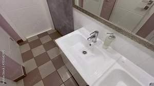 Modern washbasins and bathroom stalls (restroom cubicles) in a public restroom with a large mirror