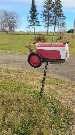In Maine, a tractor mailbox; farmer shows farming pride with a tractor mailbox. How intricate!