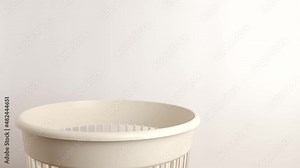 A Christmas tree toy in the form of a shoe is thrown away in a landfill for disposal and recycling