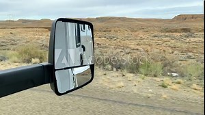 Camper Van Side Mirror Travel On The Scenic Road Through The Colorado Desert In The USA. POV Shot