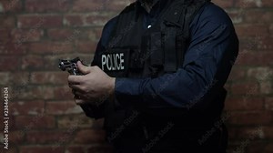 A police officer demonstrates the use of his weapon