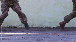 Group of soldiers from Task Force five people moving in front