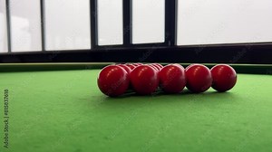 red billiard balls are collected together. start of the game snooker. green table.