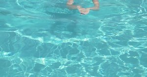 Hot beautiful woman swimming in the pool