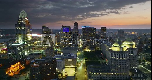 Aerial view of downtown district of Cincinnati city in Ohio, USA at night. Brightly illuminated high skyscraper buildings in modern American midtown