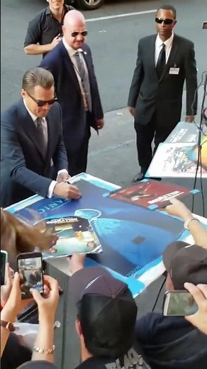 Leonardo DiCaprio Signs "Titanic" Movie Poster At "Once Upon A Time In Hollywood" Premiere.