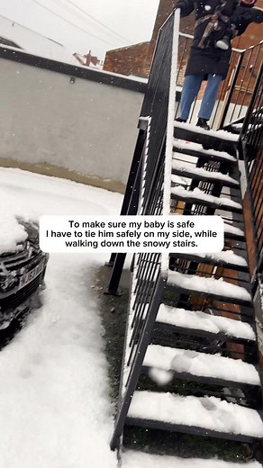 To make sure my baby is safe I have to tie him safely on my side, while walking down the snowy stairs. | Onyinyechi Family