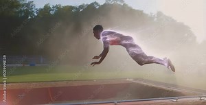 As the long jumper leaps, an explosion of glowing particles visualizes his power, creating a dazzling energy trail that highlights his full strength mid-air