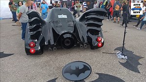 The Batmobile is the iconic, high-tech, and sleek automobile used by the DC Comics superhero Batman. It serves as Batman's primary mode of transportation when fighting crime in the fictional Gotham City. The design of the Batmobile has evolved over the years, with various adaptations in comics, movies, and television series, but it typically features a dark, intimidating exterior, advanced weaponry, and cutting-edge technology, making it a formidable asset in Batman's crime-fighting arsenal. The