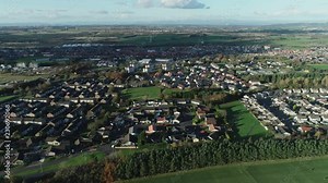 Aerial footage over the town of Whitburn in West Lothian, Scotland.