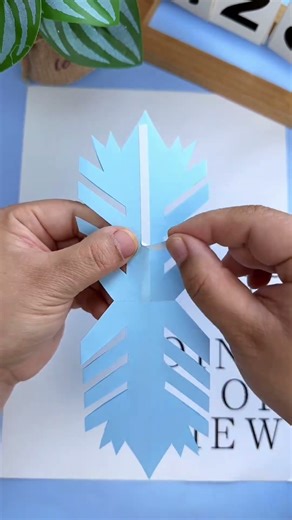 Make a beautiful 3D origami snowflake with your child! The finished product is absolutely stunning