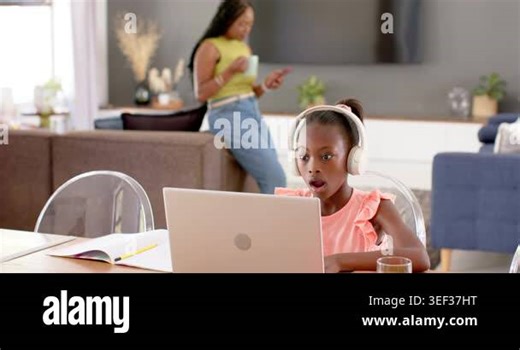 Mother and child, girl wearing pink top, white headphones reacting to laptop lesson at home, typing. Daughter, parent, learning, study, computer, livingroom, daylight Stock Video Footage - Alamy
