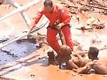 Woman is pulled from mud by workers after Brazil dam collapse
