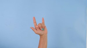 Download Female hand showing I Love You sign isolated on pastel blue background in studio. Pack of Gestures movements and body language. Love hand sign for free