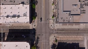 Aerial view of a busy downtown city with roads, cars, and pedestrian crossings. Urban environment featuring intersections and buildings Stock Video