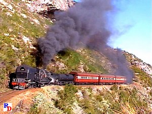 Conquering a mountain grade called Montagu Pass with a passenger train is South African Railway's GMA class Garratt locomotive No. 4072. An impressive sight! The locomotive is a 4-8-2 2-8-4 and runs on 3 foot, 6 inch (Cape gauge) rails. From the Machines of Iron show "South African Garratts" https://rfd.video/SAGarratts | Steam Giants