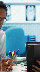 Vertical Video General practitioner presenting the test findings via scan interpretation on tablet, discussing about the diagnostic and possible treatment. Medical expert provides advice to patient