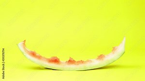 Eaten watermelon slice stop motion animation on yellow background. Summer time fruit.