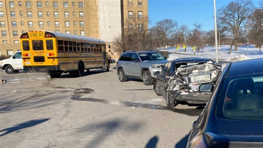School bus with 11 children on board crashes into car after sliding on ice