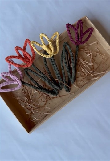 These started as long strands of I-cord, made with my French knitting machine—soft, rhythmic, and weirdly satisfying to watch. Once the cords are done, I thread wire through the center and slowly shape each one into petals. The result: sturdy little flowers in warm autumn shades—terracotta, mustard, plum, sage, blush. They hold their shape, feel like the season, and bring a touch of something cozy and unique to any space. #knottedthreads #autumnvibes #fyp #100kfollowers #smallbusiness