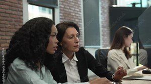 Team of Female Software Developers Collaborating on Code, Focused Programmers Working Together in Modern Office, Diverse Group of Women in Technology Industry, Professional Workspace Collaboration.