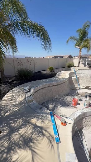 A little refresh goes a long way💦 This remodel got a brand new mini pebble interior, upgraded tile and stack stone, and a sheer descent that adds the perfect touch of movement and sound. | Majestic Pool Construction