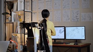 Teen Asian Girl Walking To Look At The Pictures On The Wall While Working About A Cyborg Hand At Home