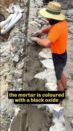 Capping stones complete this retaining wall #stonewall #retainingwall #stonemason