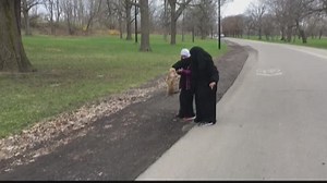 Women free animal with head stuck in jar