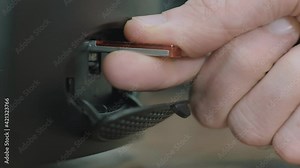 Person inserting a usb flash drive in a computer.