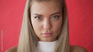 Angry woman face expression. Resentful. Close up of upset model face. Sad girl face expression. Portrait of unhappy woman looking in camera on white background. Negative female emotion