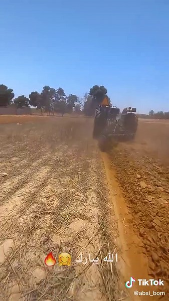 Black Tractor Working in Dry Field