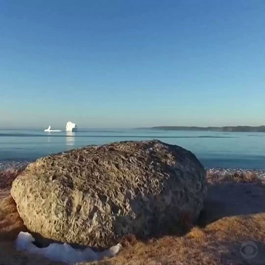This iceberg has run aground near a small, coastal Canadian town, and tourists are flocking to it. http://cbsloc.al/2pmWF33 | CBS News