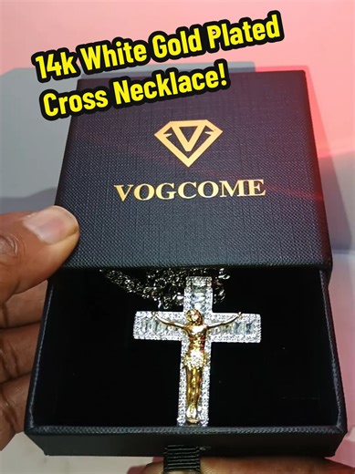Vogcome 14 Karat White Gold Plated Cross Necklace is a bold 24 inch necklace designed to shine with confidence and lasting quality, crafted to resist fading, discoloration, and turning your skin green so you can wear it every day without worry. This large oversized men's cross necklace features a brilliant iced-out crucifix design with a detailed gold-tone center set against a sparkling white gold plated finish, creating a powerful statement piece that instantly elevates your style. Whether you 