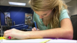 Girl working on her homework in a computer lab.