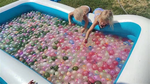We celebrated the end of summer with an epic water balloon fight! We filled, threw, and smashed over 3000 water balloons and had an amazing party with our neighborhood friends! What is your favorite way to crash into fall? #summervibes #neighborhood #familyfriendly | Diapers On A Plane