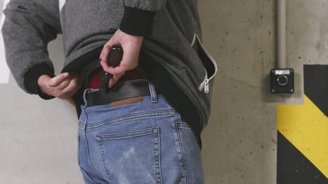 clip-3994755831-older-man-big-revolver-handgun-exploring-dangerous