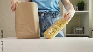 woman takes groceries out of bag, selecting fresh produce at the supermarket, healthy food choices