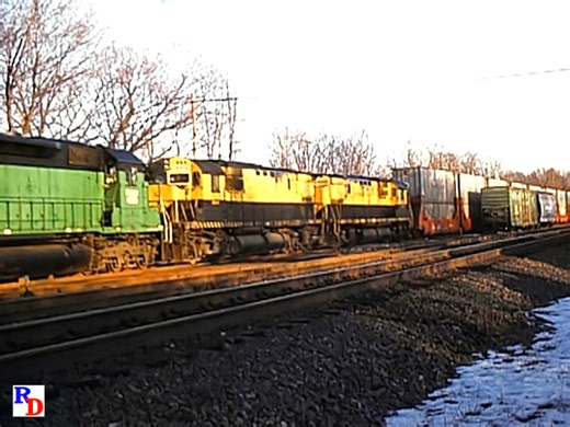 An early era NYS&W SeaLand Stack train rolls into Maybrook, NY where the operational headache known as "The Maybrook Shuffle" took place in order to turn the train. The train is seen again as it heads to New Jersey. From the JPM show "New York Susquehanna and Western Operations in the 1980s" https://railfandepot.com/producer/john-pechulis-media | Railfan Depot