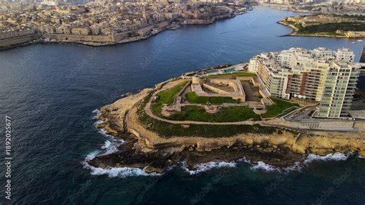 Drone aerial view of Fort Tigne at Tigne Point in Sliema with Valletta and the Mediterranean Sea in Malta.