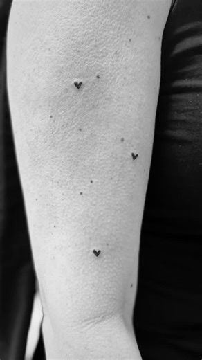Joanne Rebecca on Instagram: "FRECKLE HEARTS 🖤 I mean who doesn’t need a freckle heart. My client has opted for 3. One for each of her babies. FRECKLE HEART | 15MINS | £40 (Each additional heart will be charged at £5 per heart) Appointment only. Book in via the link in my bio 📩 • • • • #tattoos #tinytattoos #finelinetattoos #smalltattoos #smalltattoosforgirls #freckletattoo #microtattoo #skinink #joannerebeccacosmeticsandbeauty #clare #suffolk"