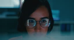 Closeup of Female computer programmer works on complex software...