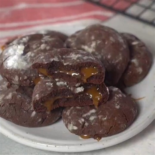 Caramel Chocolate Crinkle Cookies! Chocolate Crinkle Cookies are kicked up to a new level! Soft and chewy caramel-filled chocolate crinkle cookies will be wonderful on your cookie platters :) This cookie is like a caramel brownie in a perfect cookie form, with individual deliciousness serving guaranteed. Click my bio for the recipe: https://mooreorlesscooking.com/caramel-chocolate-crinkle-cookies-video/ #chocolate #caramel #cookies #cookiesofinstagram #cookiestagram #crinkle #christmas #christma