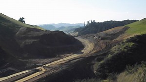 Huntly section: The big excavation at the Taupiri Pass is nearly complete with a final blast last week required for widening rather than for depth. About 8 tons of explosive was used and 2000m of drilled holes. The result is 40,000 cubic metres of blue/brown rock loosened which will to be used for subgrade improvement layers – the solid base for the road. All up 1.2 million cubic metres of material has been removed to create a 57m deep and 400m wide cutting through the hillside. All material fro