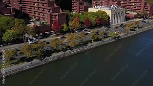 Light drone zoom of FDR Drive in Harlem, Manhattan, NYC along the Harlem River in bright midday sun. in 4K.