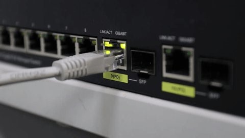 clip-3984314359-close-up-ethernet-cable-into-network-switch-port