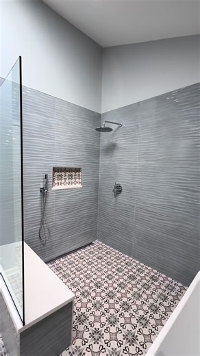 Large open wet-room style bathroom featuring hand painted tiles on the floor, wave porcelain on the walls and chrome fixtures all throughout ⁣ .⁣ .⁣ .⁣ .⁣ .⁣ #bathroom #bathroomdecor #bathroomdesign #bathroomgoals #bathroomideas #bathroominspiration #bathroominspo #bathroomremodel #bathroomremodeling #bathroomrenovation #bathroomrenovations #bathroomsofinsta #bathroomsofinstagram #bathroomtiles #homedesign #homesweethome #interior #kitchen #kitchendesign #kitchenremodel #kitchenrenovation #moder