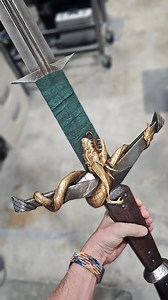 Just realized I never posted the finished Inquisition Greatsword replica! Managed to get this build to under 3lbs which really made carrying it around a con in full armor a lot easier. Resin printed cross guard, hilt, pommel, and dragon. PETG blade. Goatskin leather handle. Gold leaf and so much sanding. Base 3D model by me with dragon and texturing by @squiby_props! #dragonage #replica #sword | Volpin Props