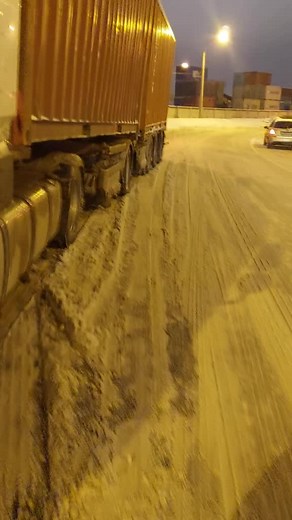 Rusty Orange Container Truck in Snowy Industrial Area