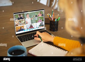 Caucasian woman using laptop for video call, with smiling diverse elementary school pupils on screen. communication technology and online education, d Stock Photo - Alamy